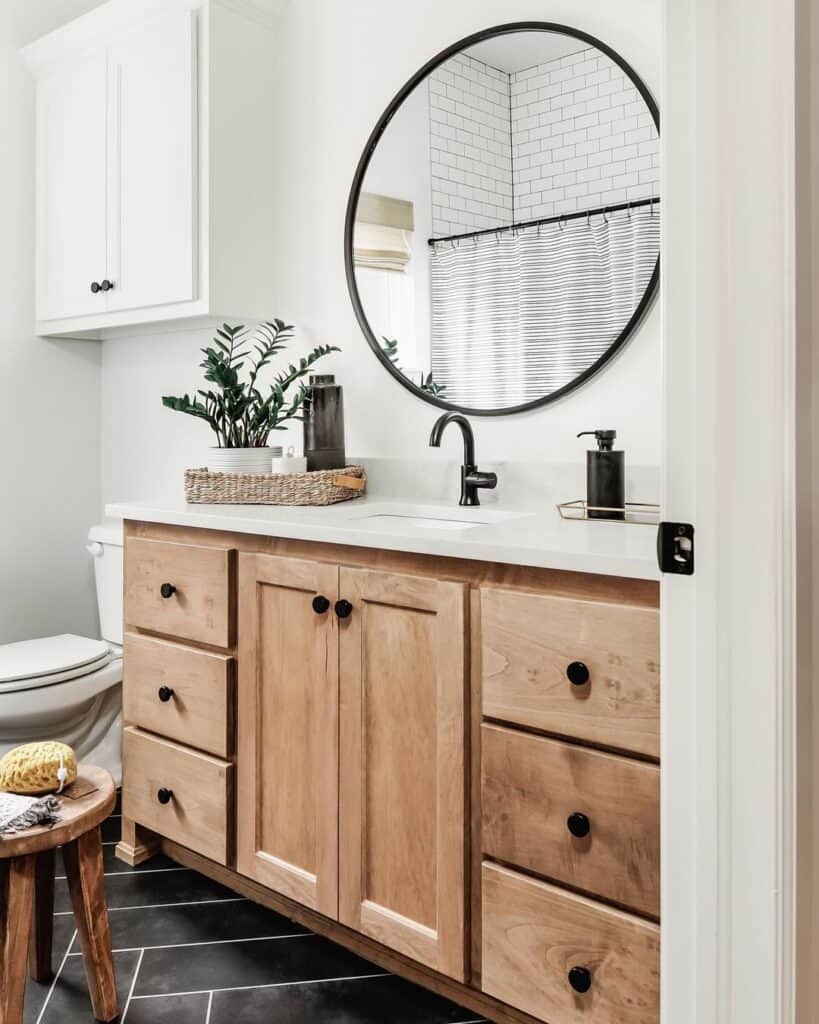 Wood Vanity on Black Herringbone Tile