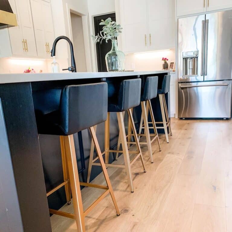 Wood and Black Bar Stools Under a White Countertop