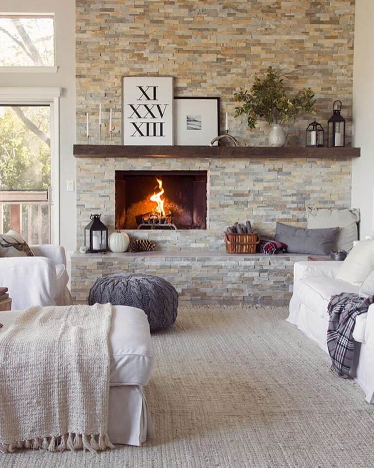 A Grey Pouf and a Stone Fireplace
