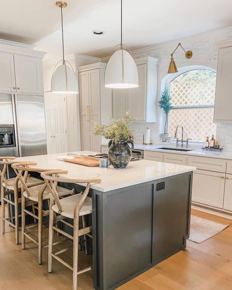 Arched Kitchen Window Between White Cabinets