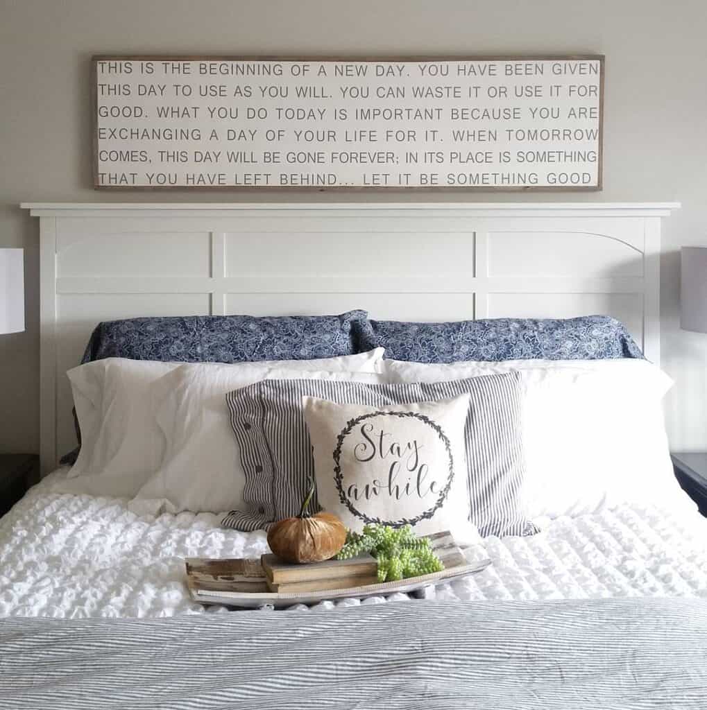 Bed with White Headboard and Wooden Sign
