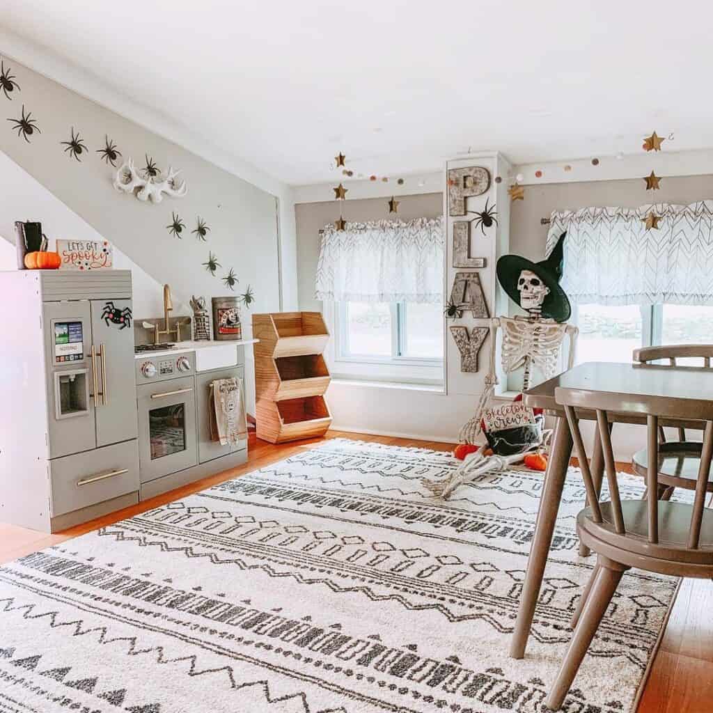 Big Plastic Spiders Above Light Grey Play Kitchen