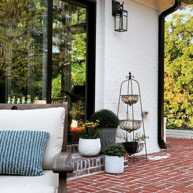 Black Farmhouse Outdoor Pendant Lighting on a White Brick House
