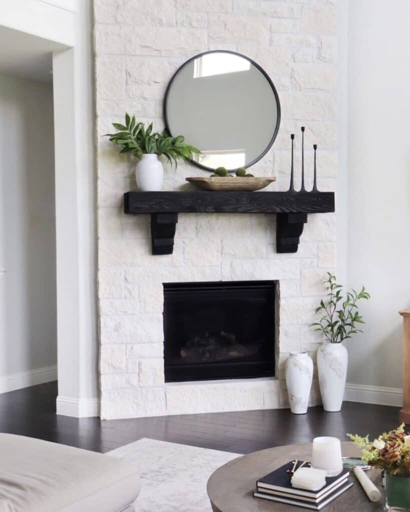 Black Mantel Above a White Stone Fireplace