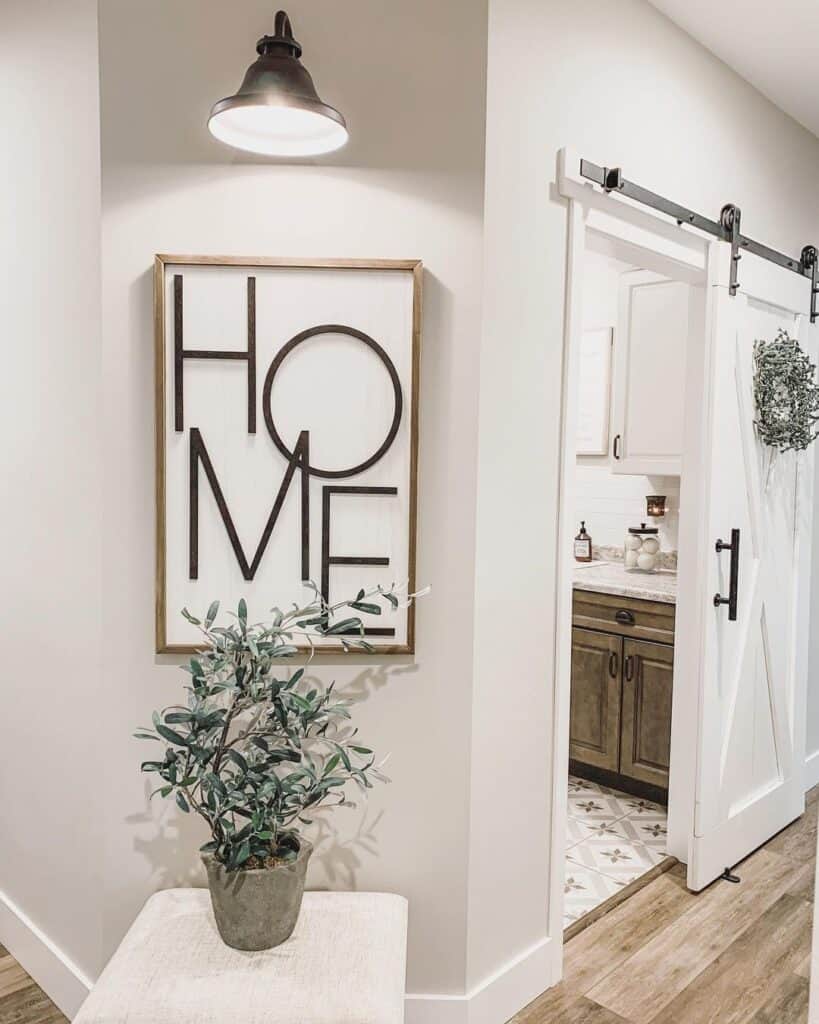 Black Sconce Above a White Sign