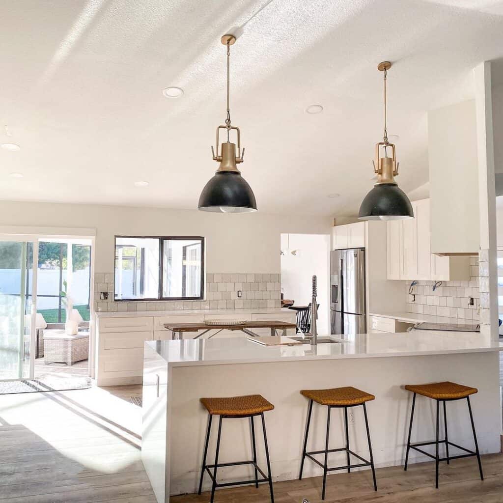 Black and Brass Lighting Above Kitchen Peninsula