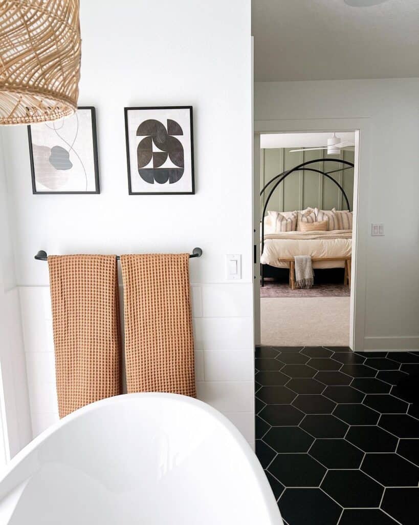 Black and White Pictures Above a Black Hexagon Tile Floor