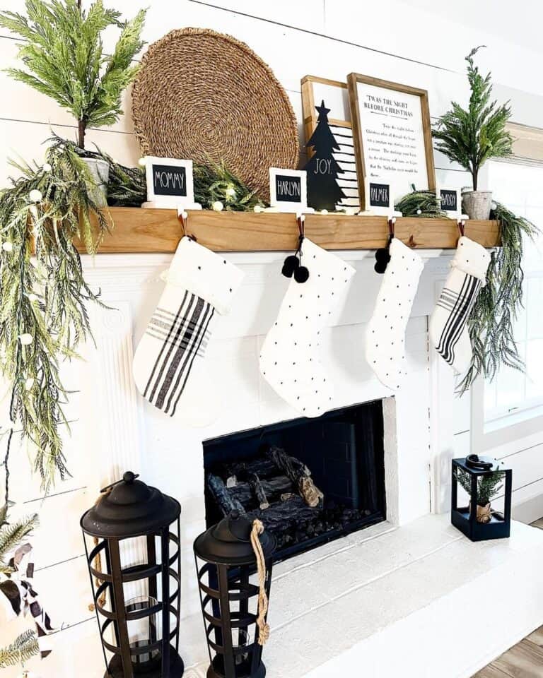 Black and White Stockings Hanging Over a White Fireplace