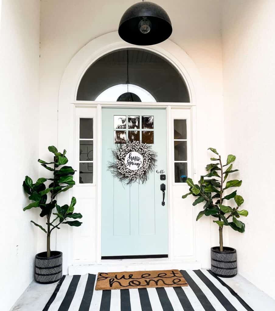 Black and White Wreath on a Light Blue Door With Sidelights