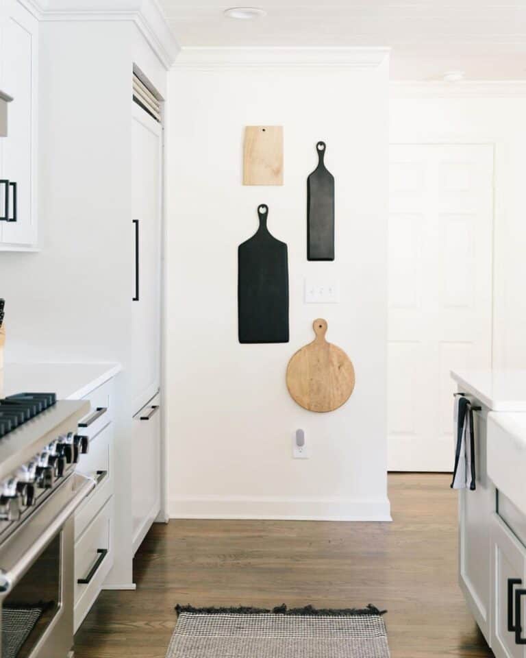 Black and Wood Cutting Boards on a White Kitchen Wall