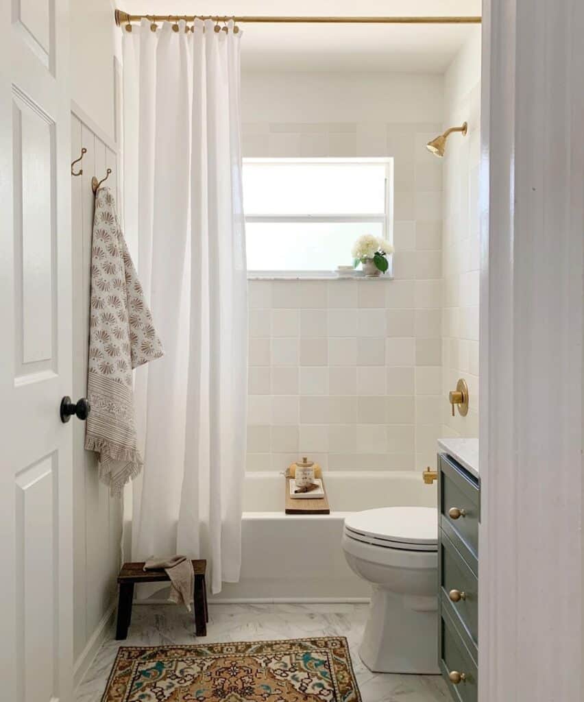 Brass Embellishments and Two-Toned Tile Bathroom