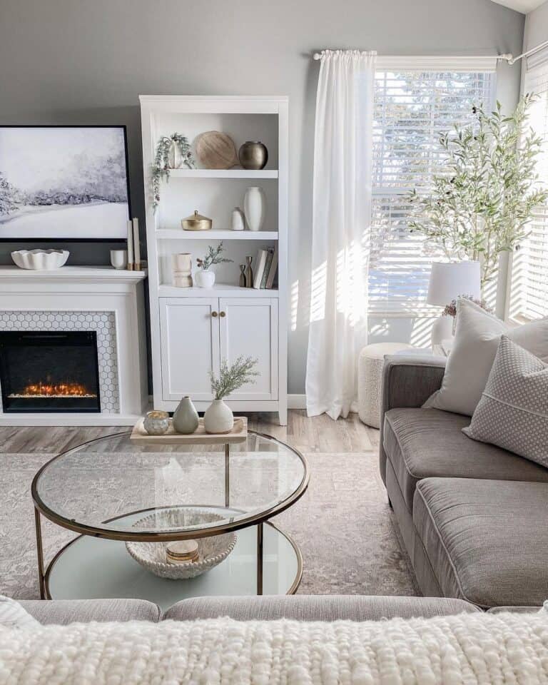 Brass and Glass Coffee Table and a Grey Sofa