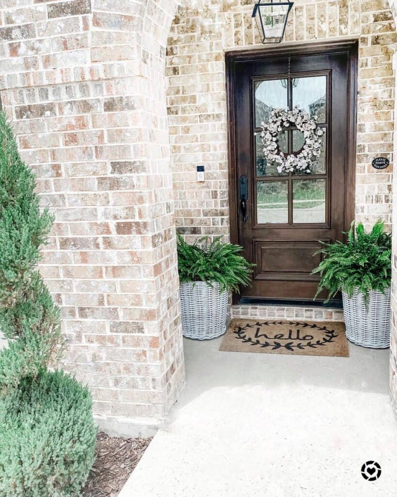 Brick Archway Leads to Wood Front Door