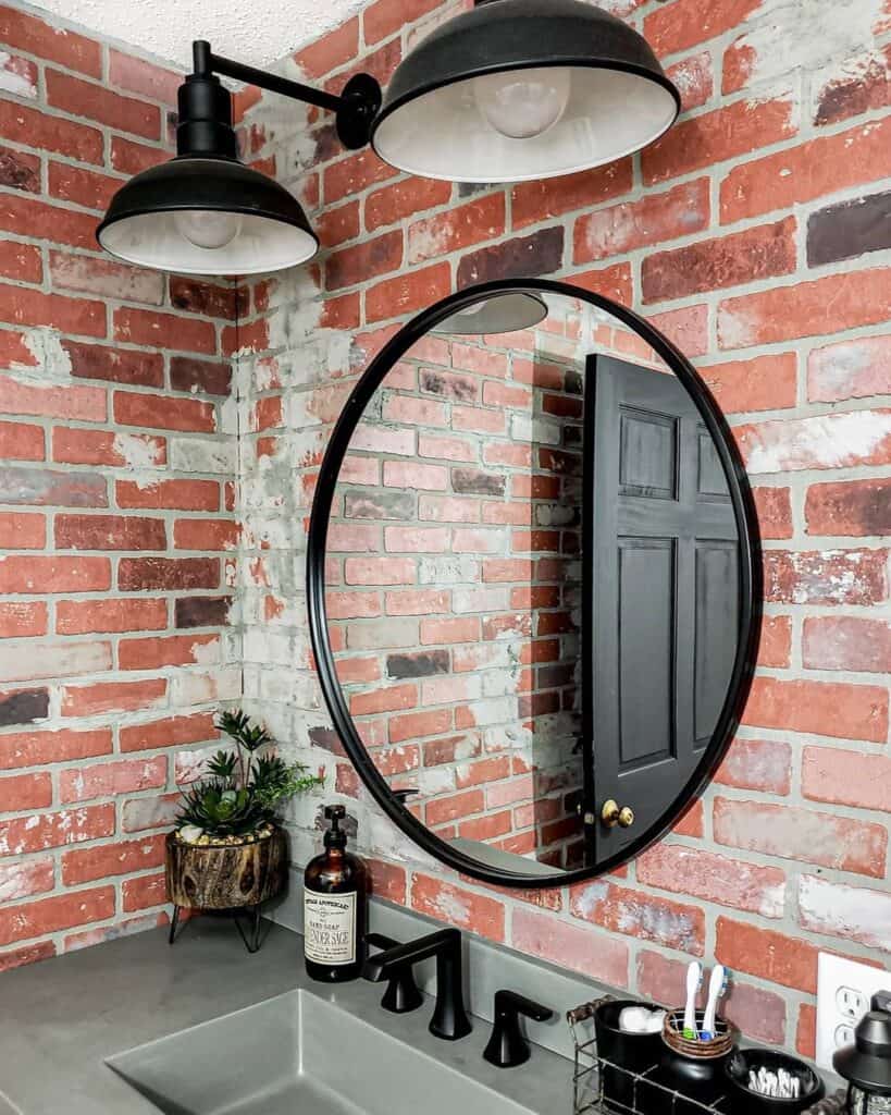 Brick Bathroom Walls with Two Black Sconces