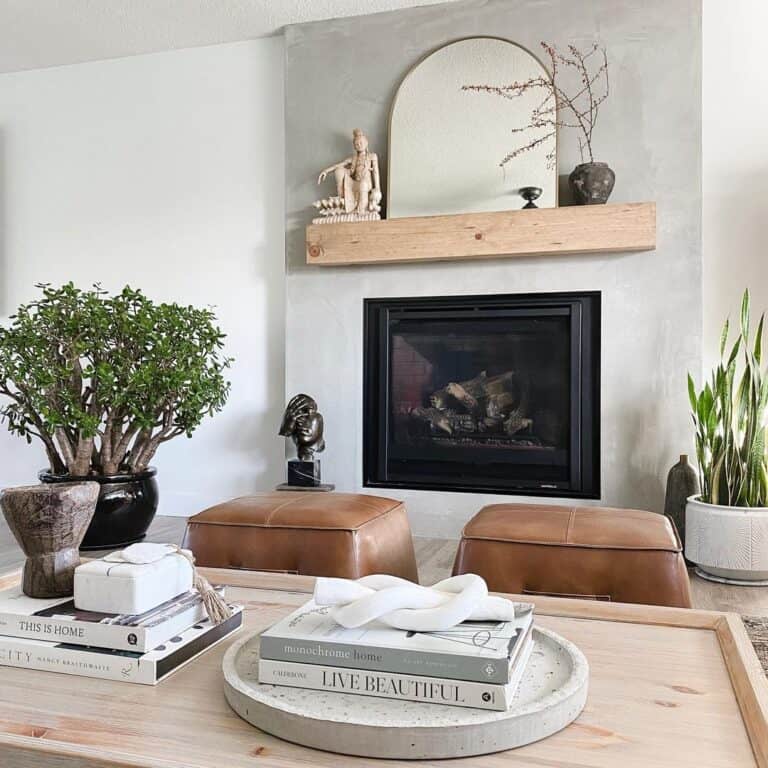 Brown Leather Poufs Near a Black Fireplace