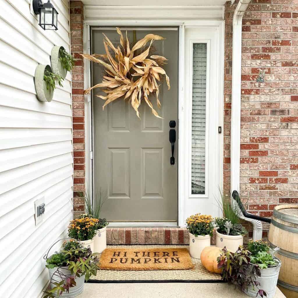 Dried Wreath on a Gray Front Door With a Sidelight