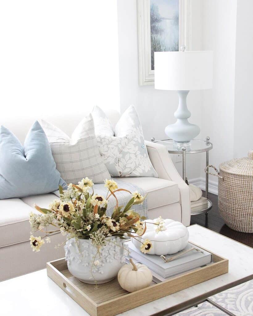 End Table with a Lamp Next to White Sofa