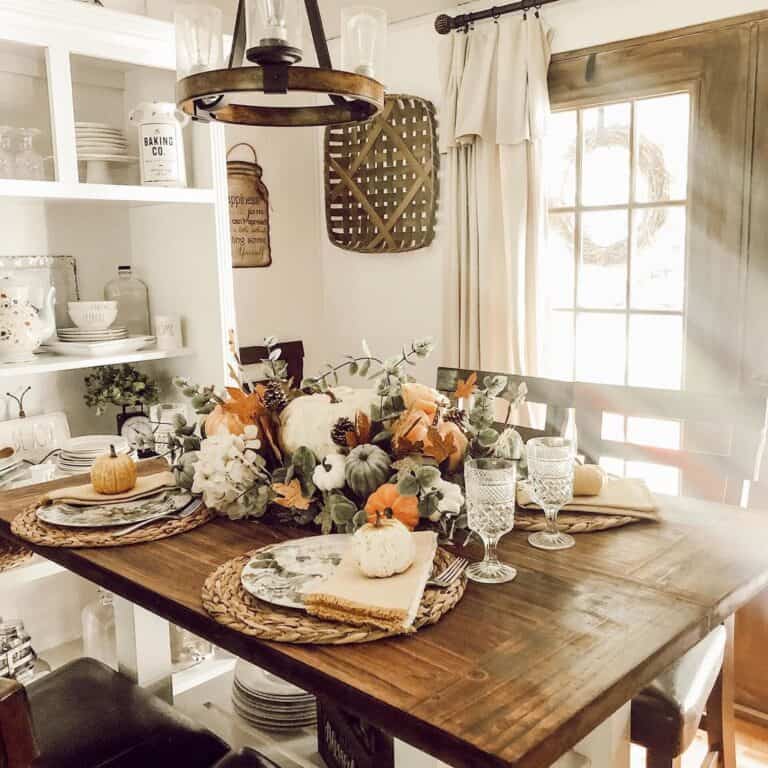 Farmhouse Dining Room with Abundant Pumpkin Centerpiece