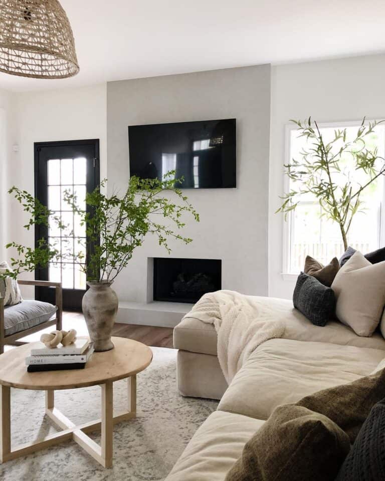 Flatscreen TV Above a Fireplace on a White Wall