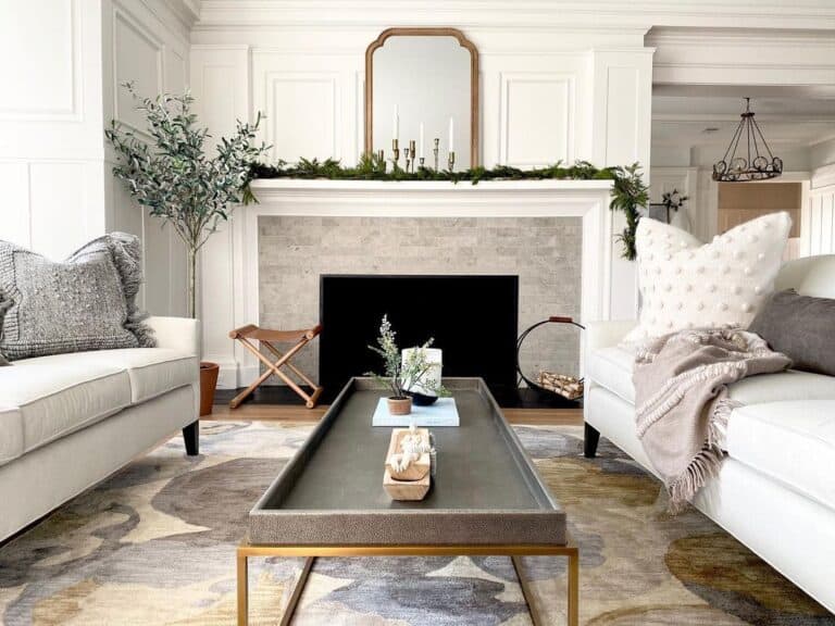 Gold Mirror and a Green Garland On a White Mantel