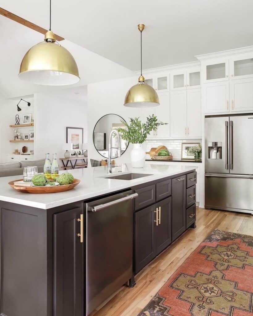 Gold Pendant Lamps Over a Black Kitchen Island