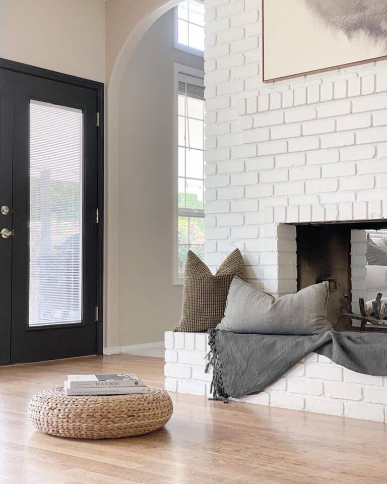 Grey Pillows on a White Brick Fireplace