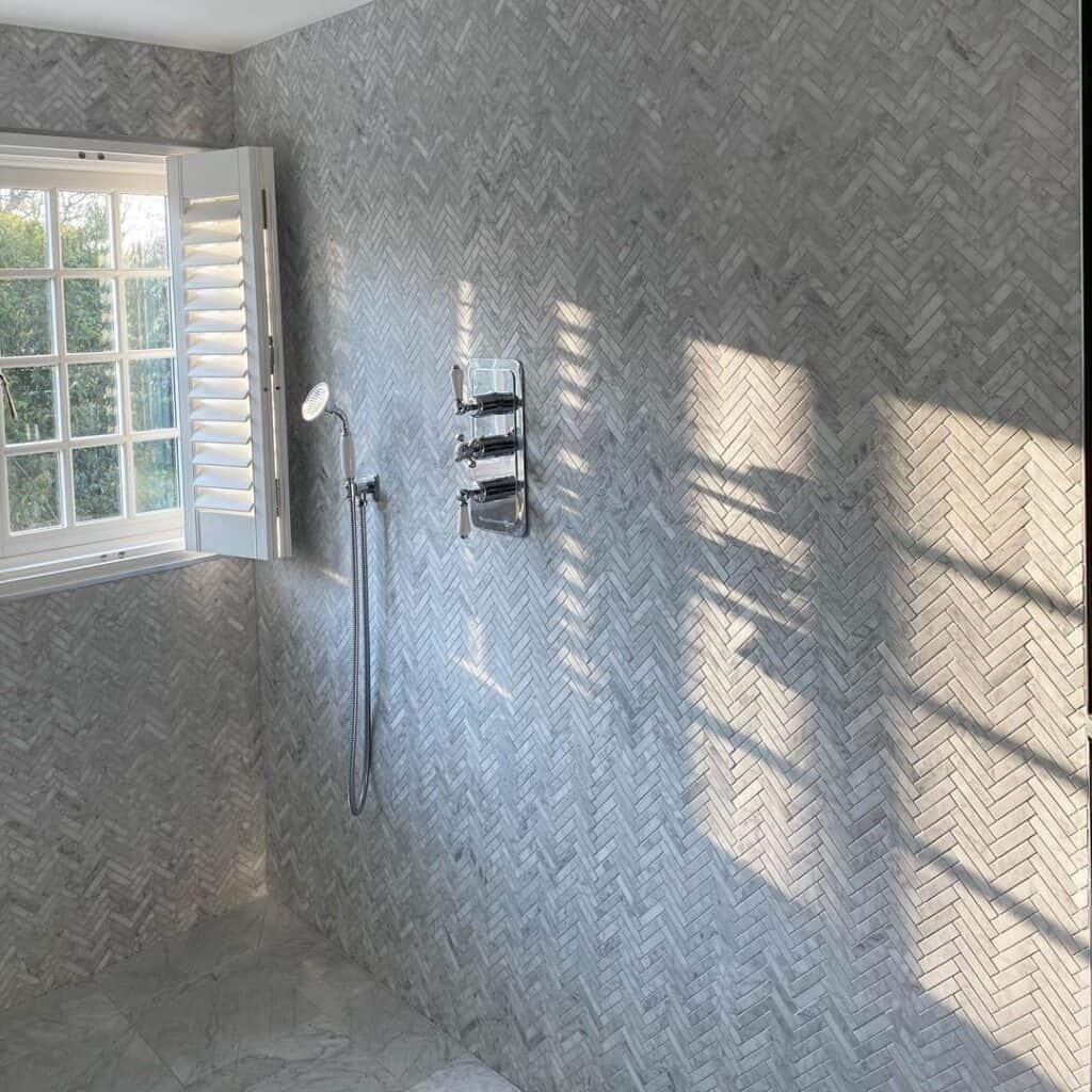 Herringbone Tile Shower Walls and Window with Shutters