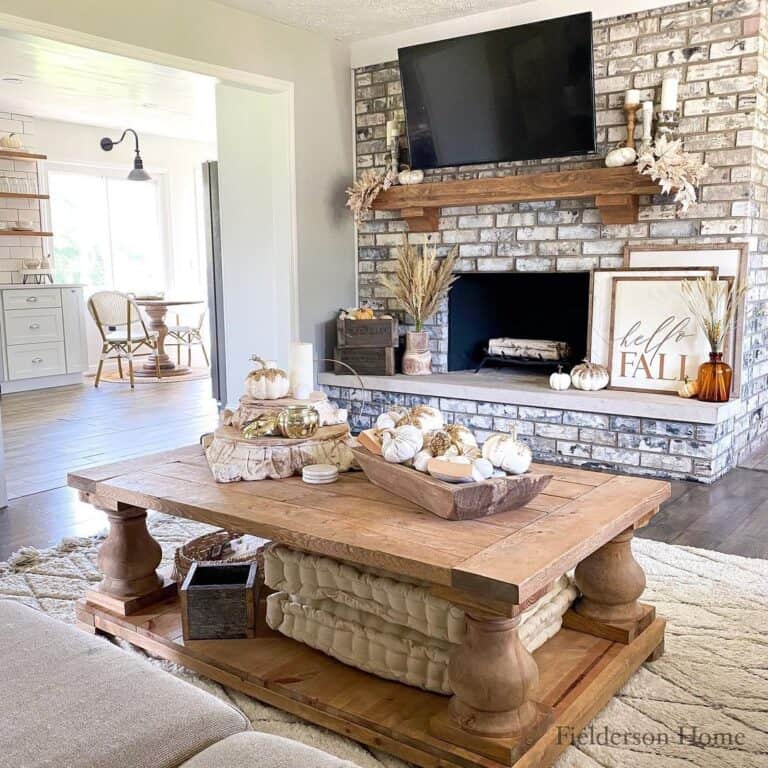 Living Room with Brick Fireplace and Fall Coffee Table Decor