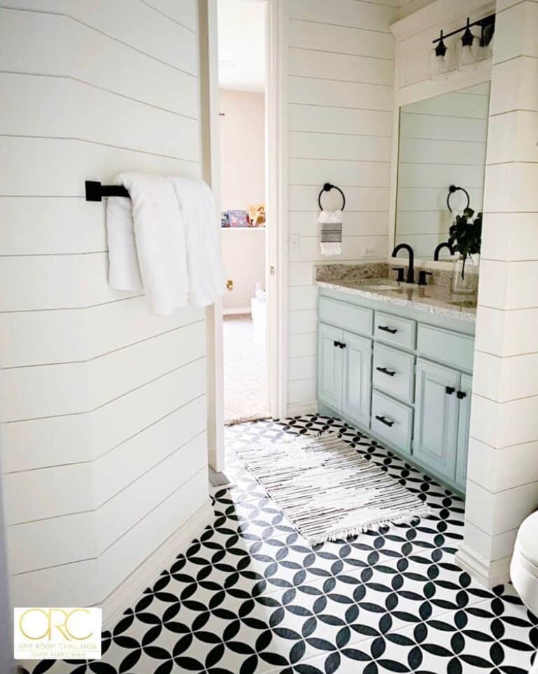 Mint-Colored Cabinet on Black and White Bathroom Floor Tile