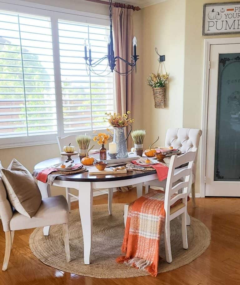 Mismatched Chairs Around White Dining Table