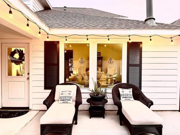 Modern Farmhouse Outdoor Lighting Above Black Rattan Chaises