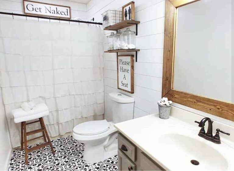 Ornate Black and White Bathroom Floor Tile and Shiplap Walls
