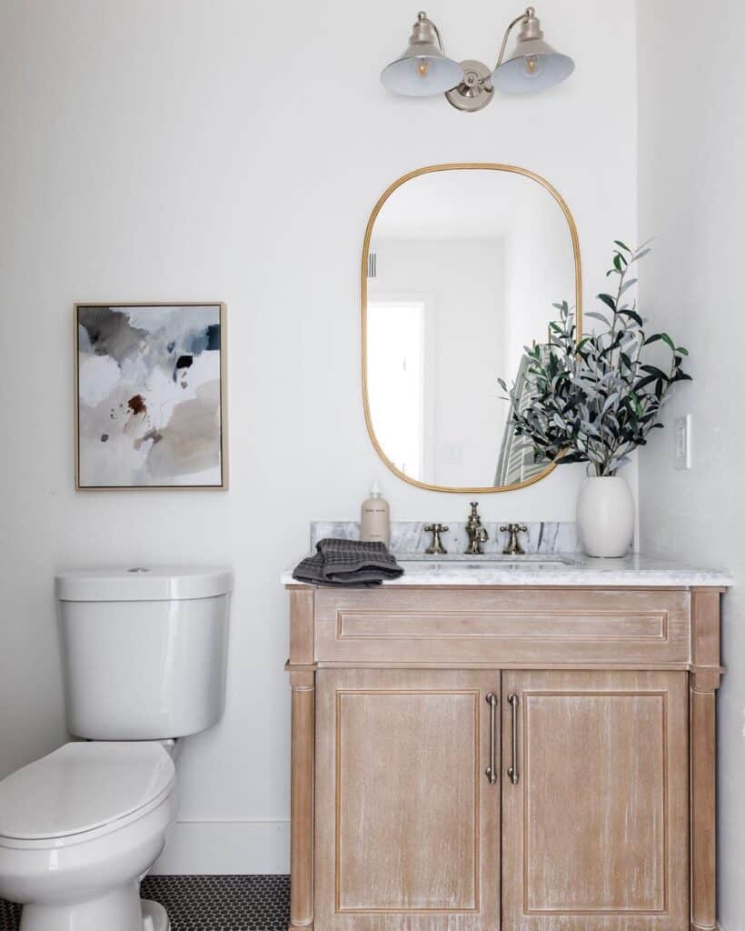 Oval Mirror and Nickel Sconce Above Vanity