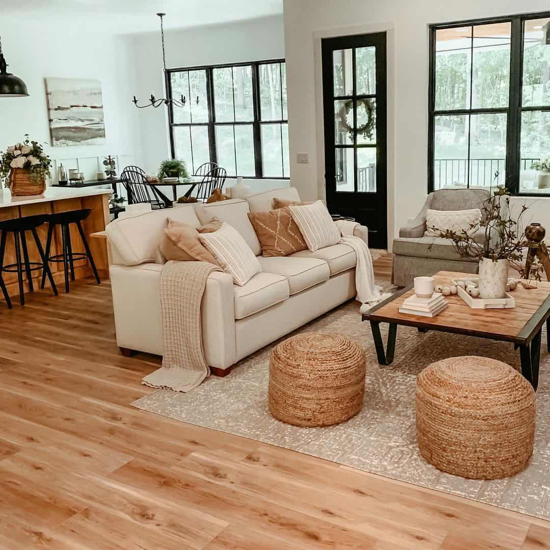 Two Rattan Poufs with a Black and Wood Coffee Table Soul & Lane