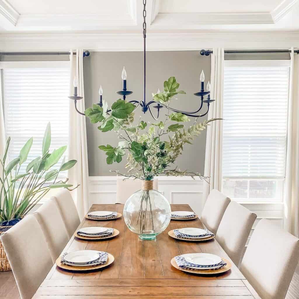 Vase of Greenery on Wood Dining Table