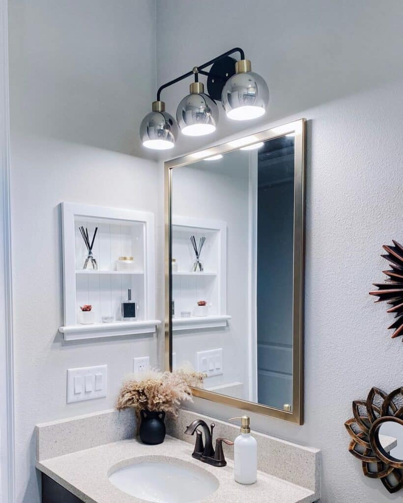 White Bathroom Walls Accessorized by Sunburst Mirrors