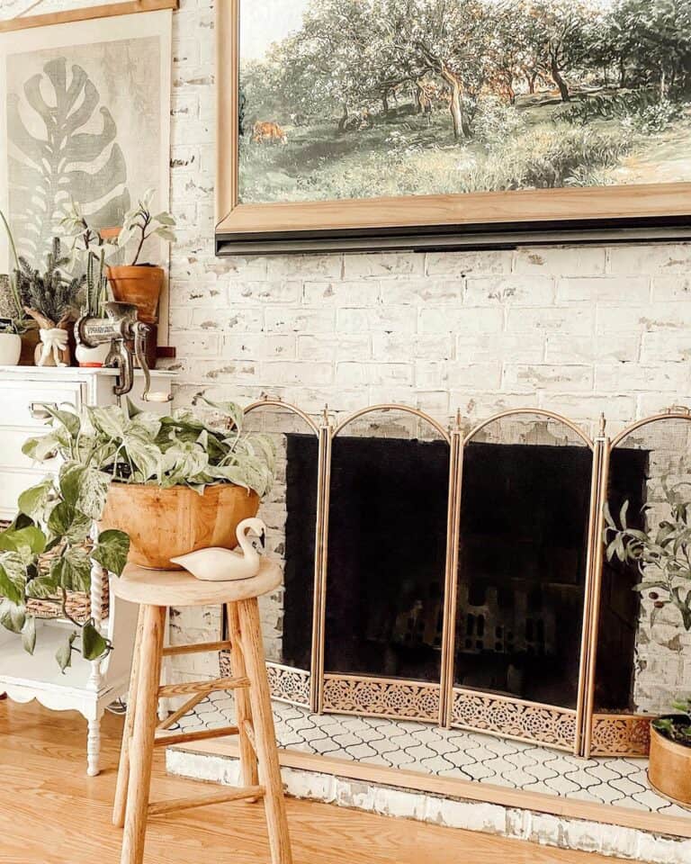 White Brick Fireplace with Gold Fireplace Gate