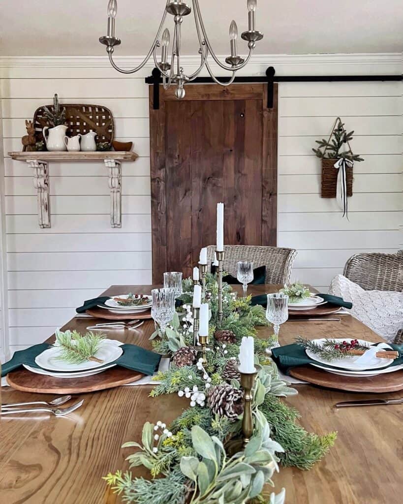 White Dining Room with Wood Table and Green Garland