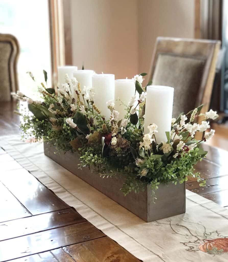 White Floral Centerpiece with Candles on Embroidered Runner