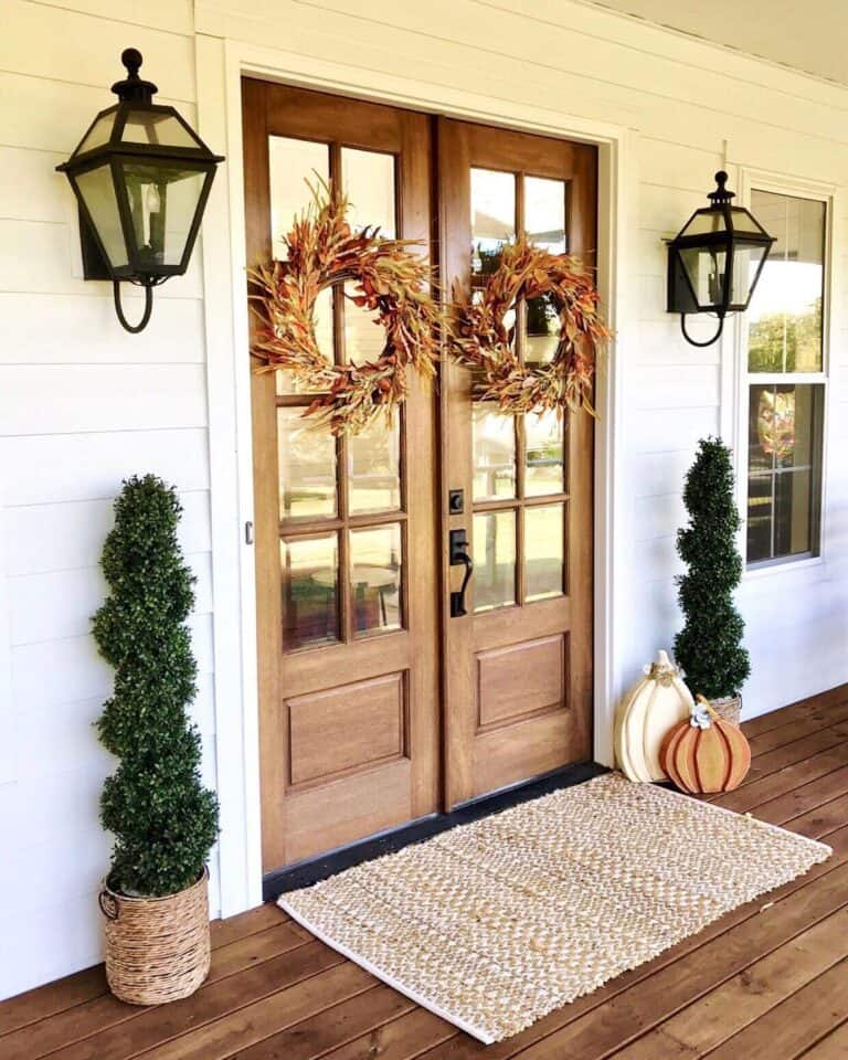 White Home with Wood French Front Doors and Autumn Wreaths