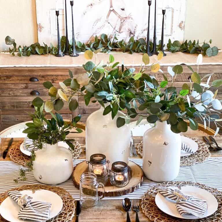 White Jugs Filled with Greenery on Dining Room Table