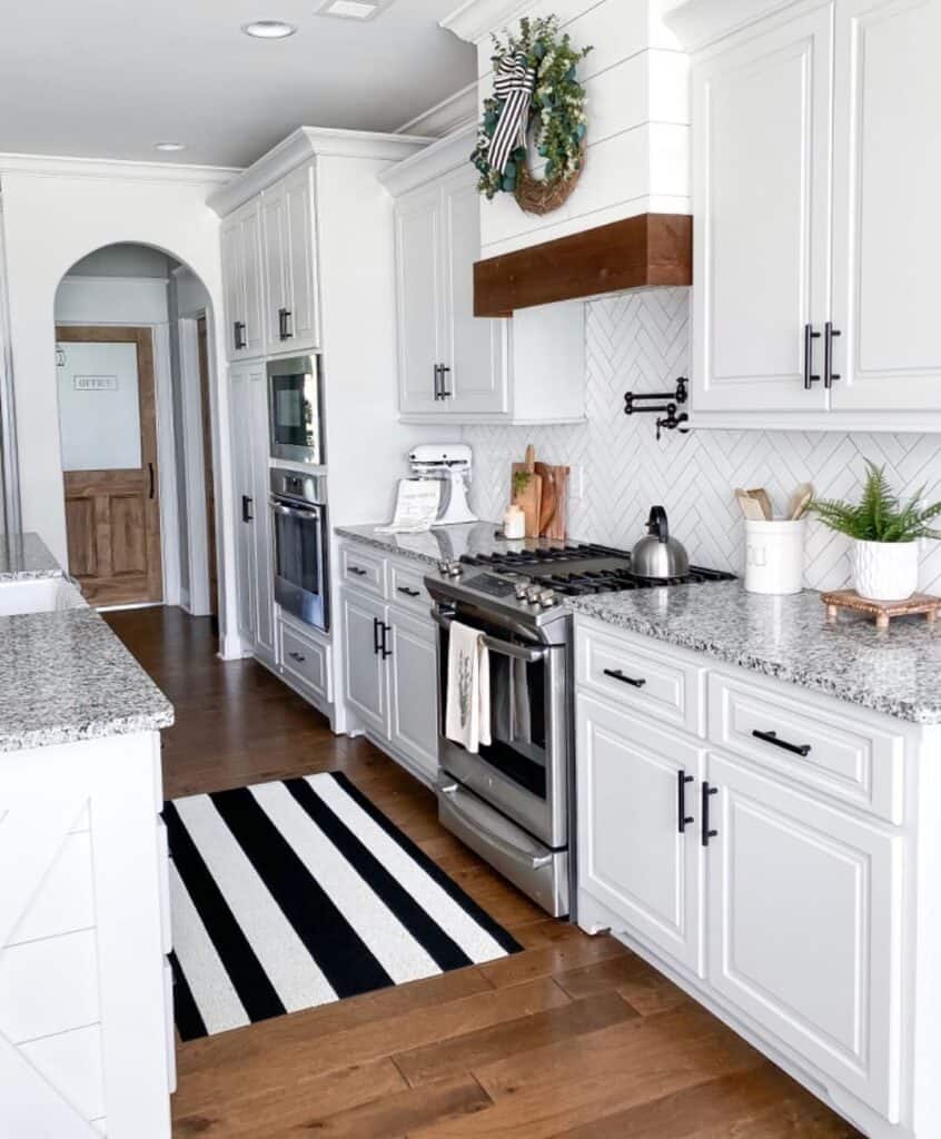 White Kitchen Cabinets with Herringbone Backsplash