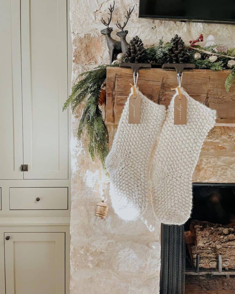 White Knit Stockings Hanging from a Rustic Wood Mantel