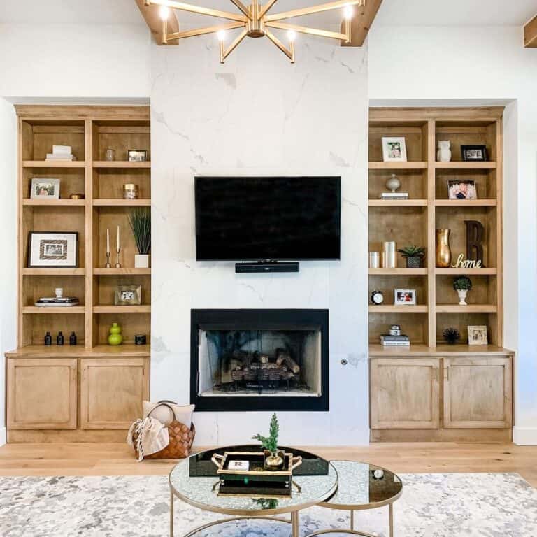 White Marbled Fireplace Between Shelving Units