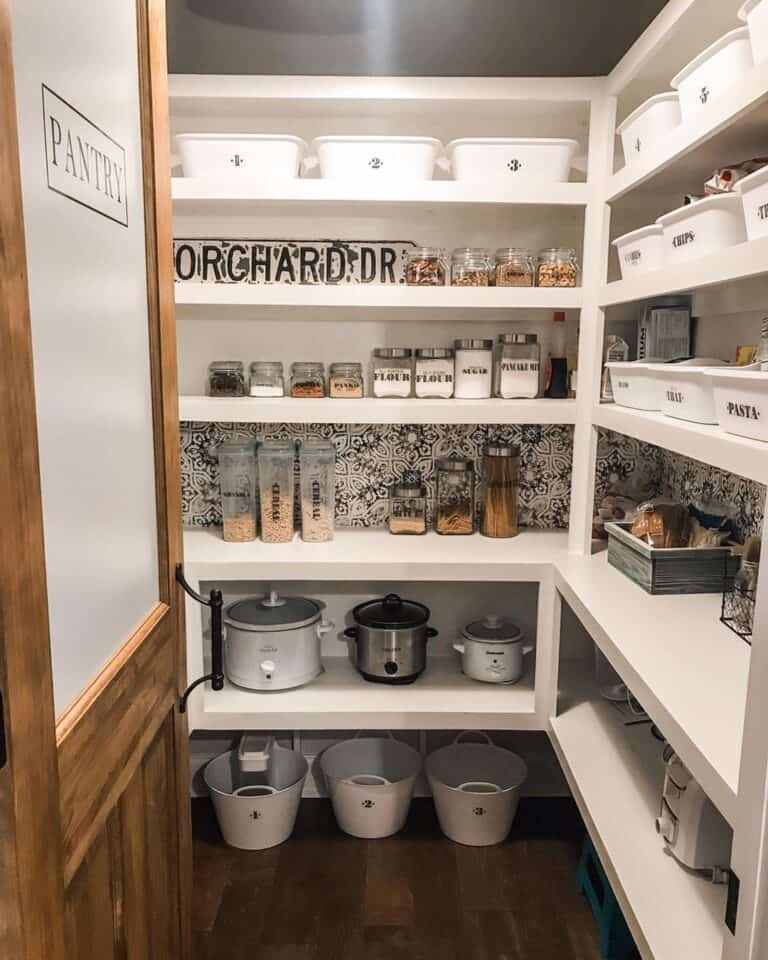 White Pantry Shelves with Wallpaper Accent