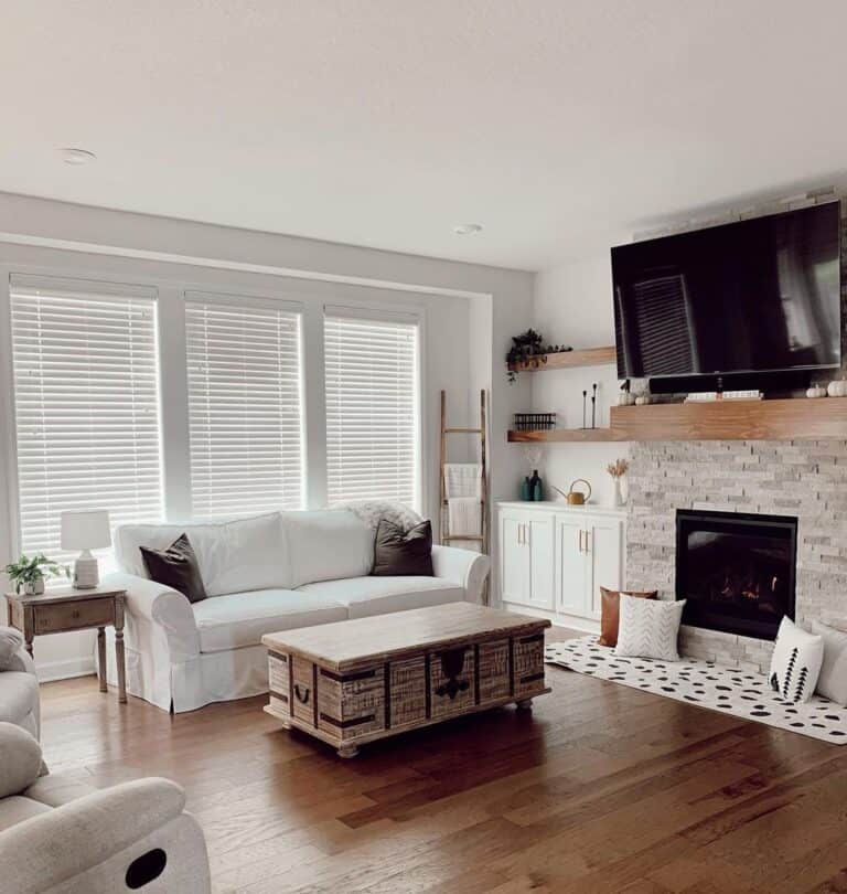 White Rug In Front of a Stone Fireplace