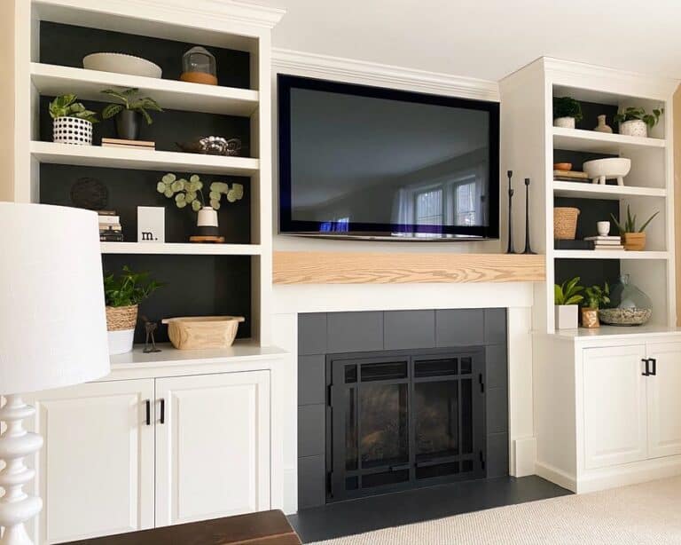 White Shelving Units and a Black Fireplace