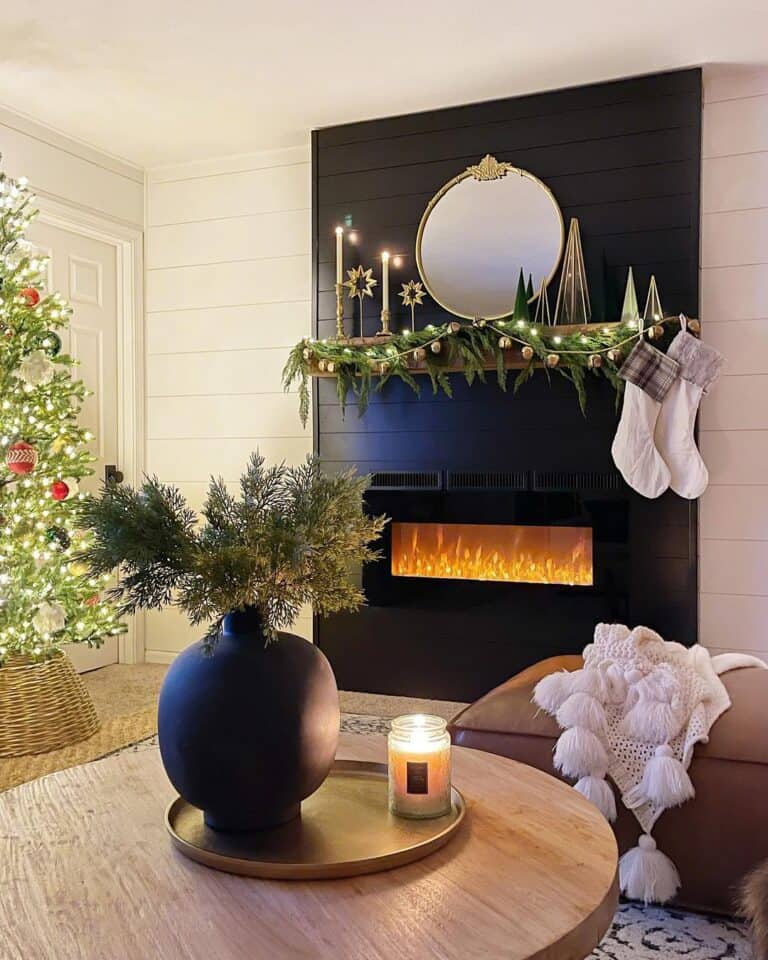 White Stockings Hanging From the Mantel of a Black Shiplap Fireplace