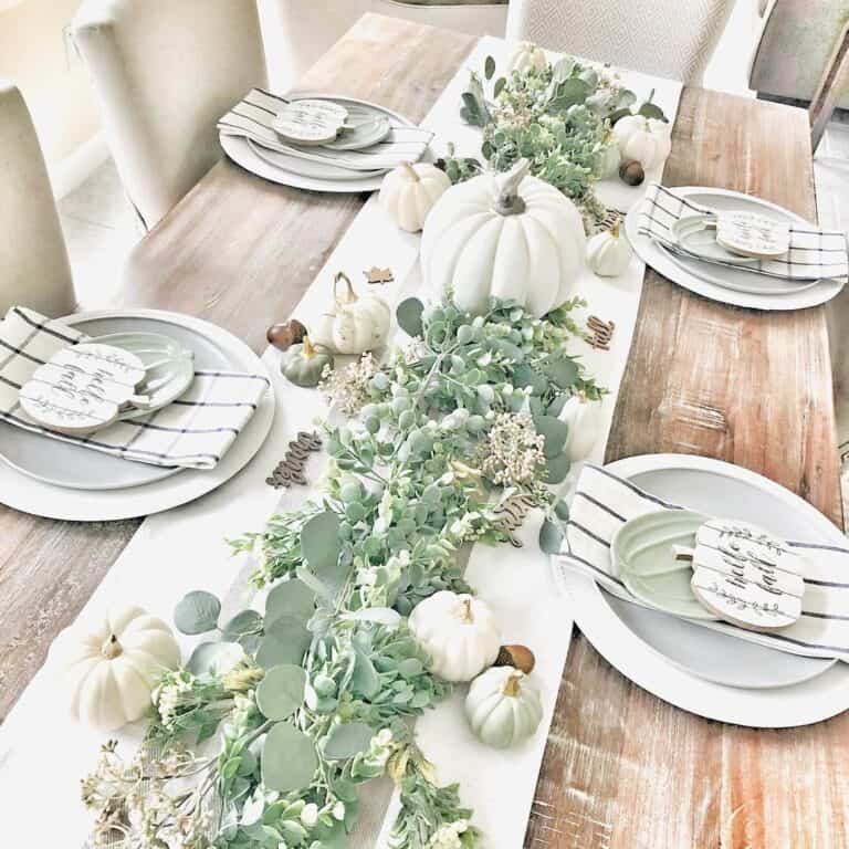 White Tablescape with Pumpkins and Green Garland