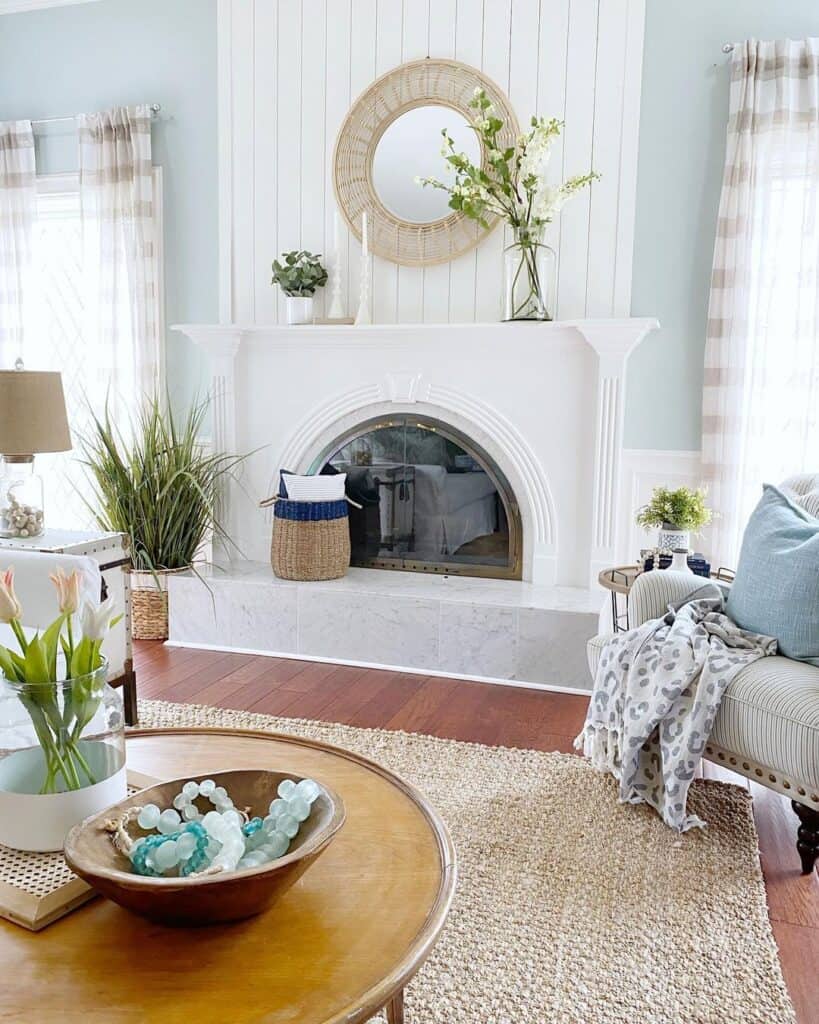 White and Blue Living Room with Arched Fireplace